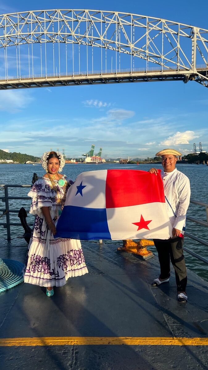 Traditional Panamanian dress with flag at Bridge of the Americas