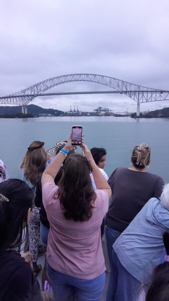 Tourists photographing Bridge of the Americas