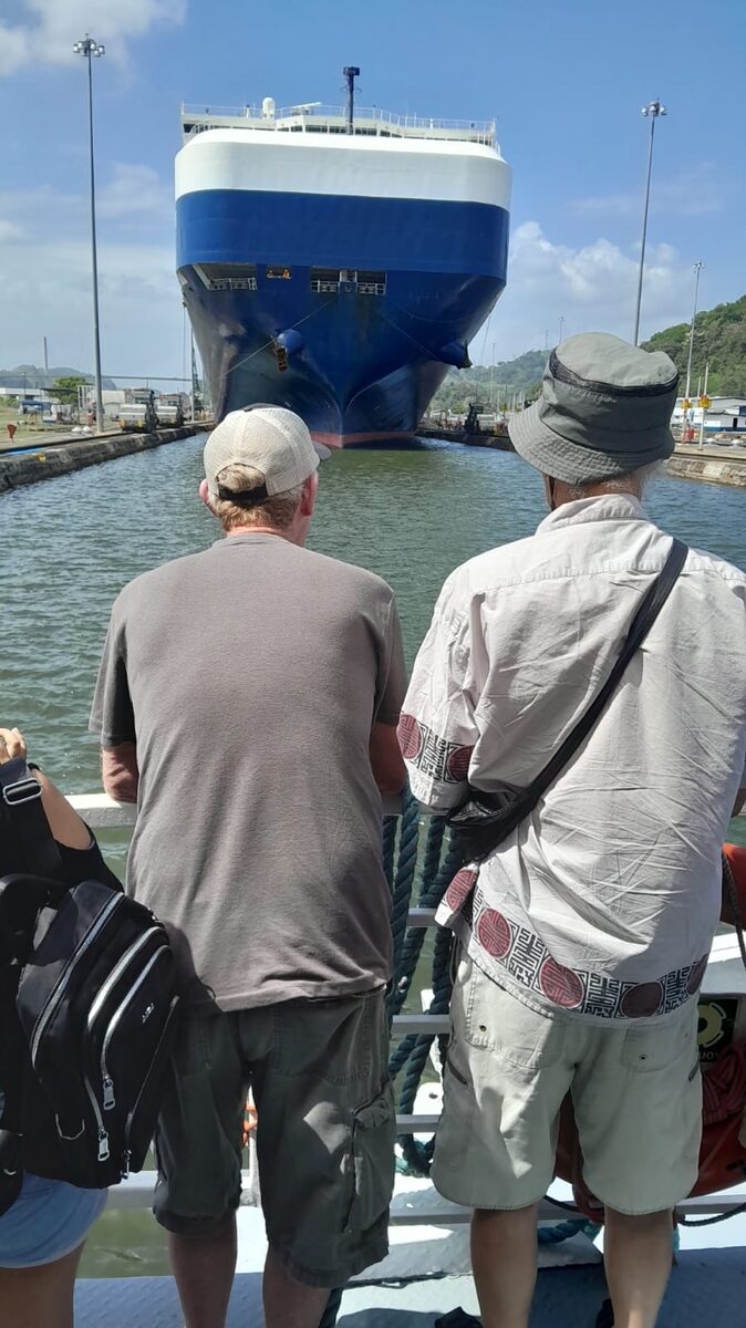 Tourists watching large ship in Panama Canal locks