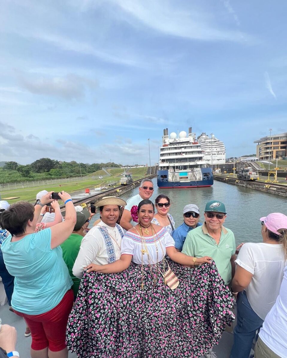Traditional Panamanian dancers with cruise ship at locks